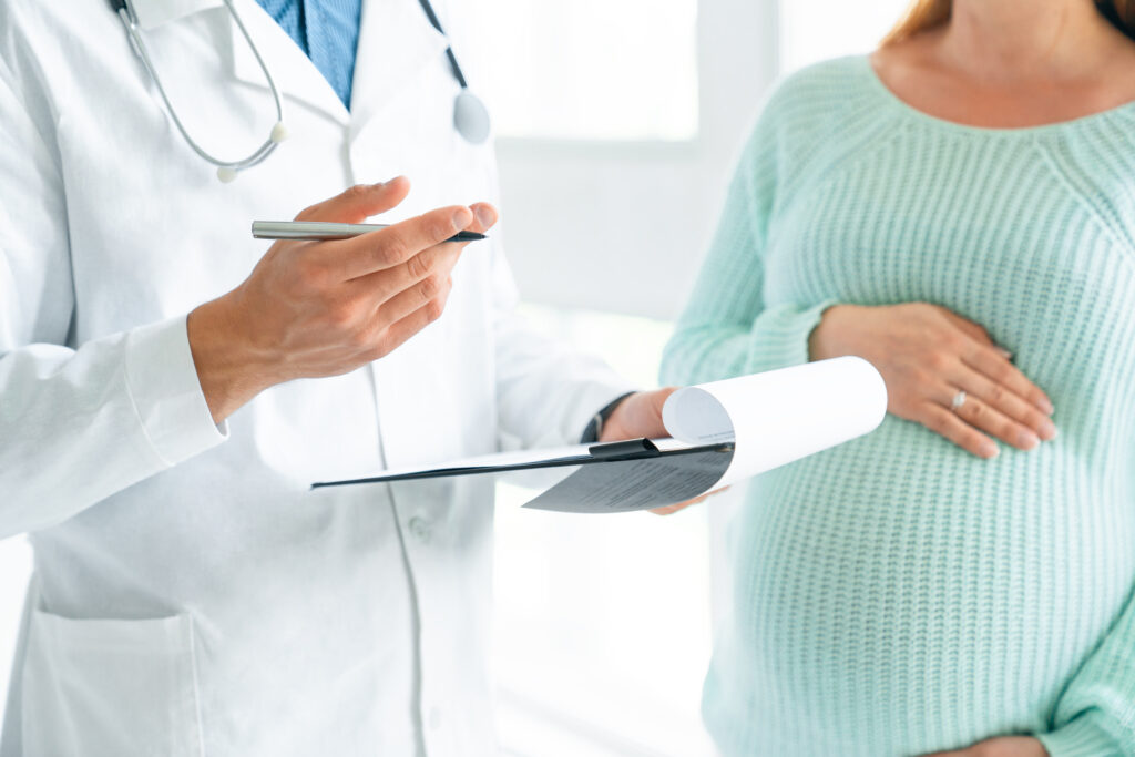 Cropped image of pregnant woman visiting doctor